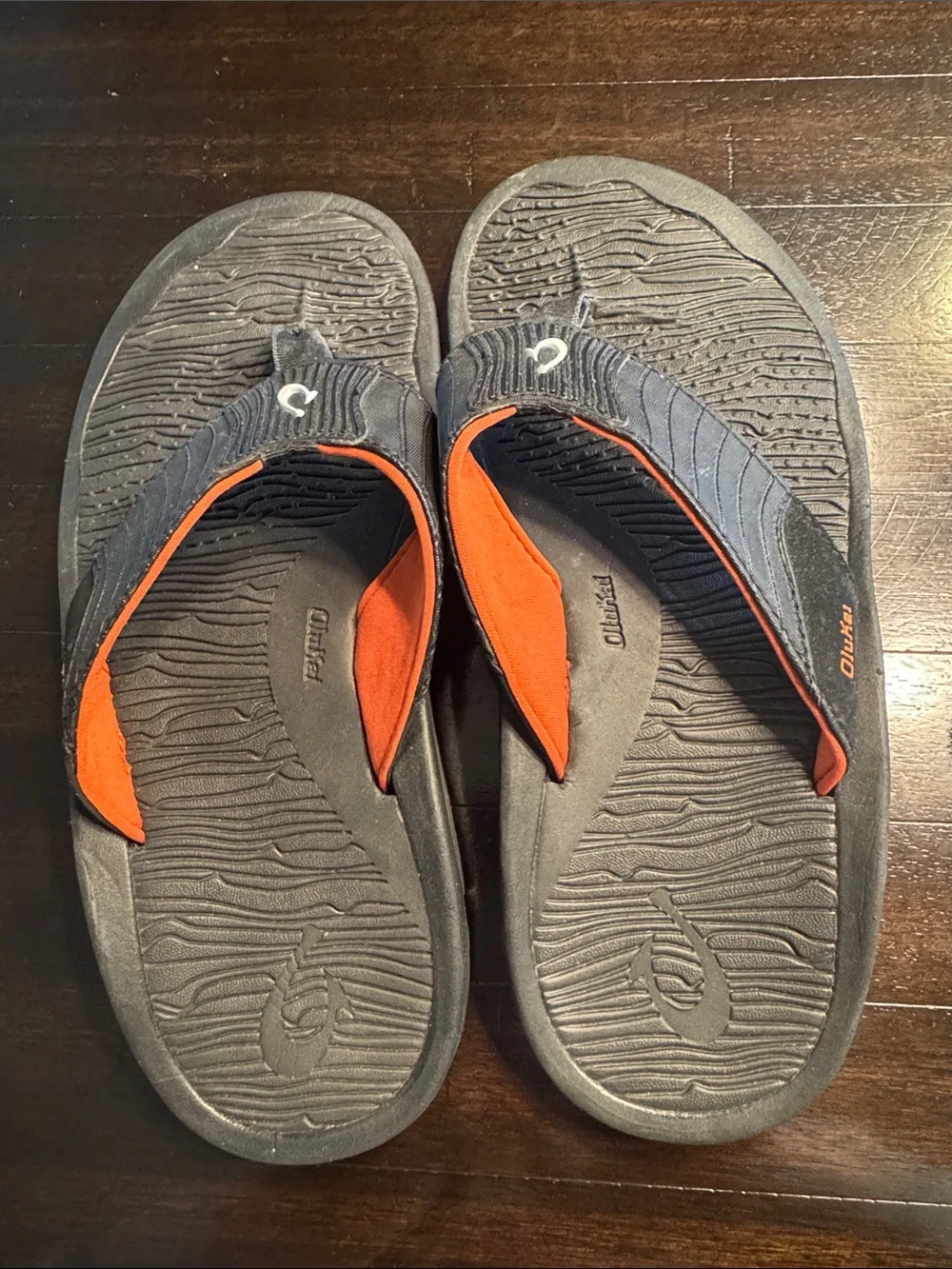 OluKai Men's Black Flip-Flops with Orange Accents